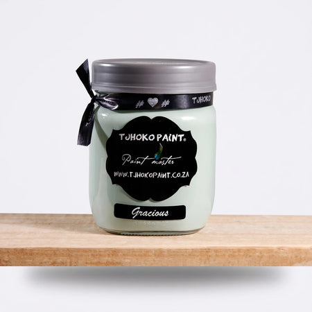 Gracious 500ml Tjohoko Chalk Paint jar in a light mint green color, displayed on a natural wooden shelf.