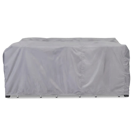 Grey protective cover for a patio furniture set, designed to shield outdoor tables and chairs from elements.