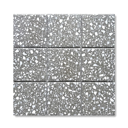 A grid of 97x97mm grey terrazzo mosaic tiles with speckled white and dark aggregate for flooring or walls.