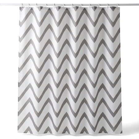 Grey and white chevron patterned fabric shower curtain hanging on a rod, showcasing its flowing wave design.
