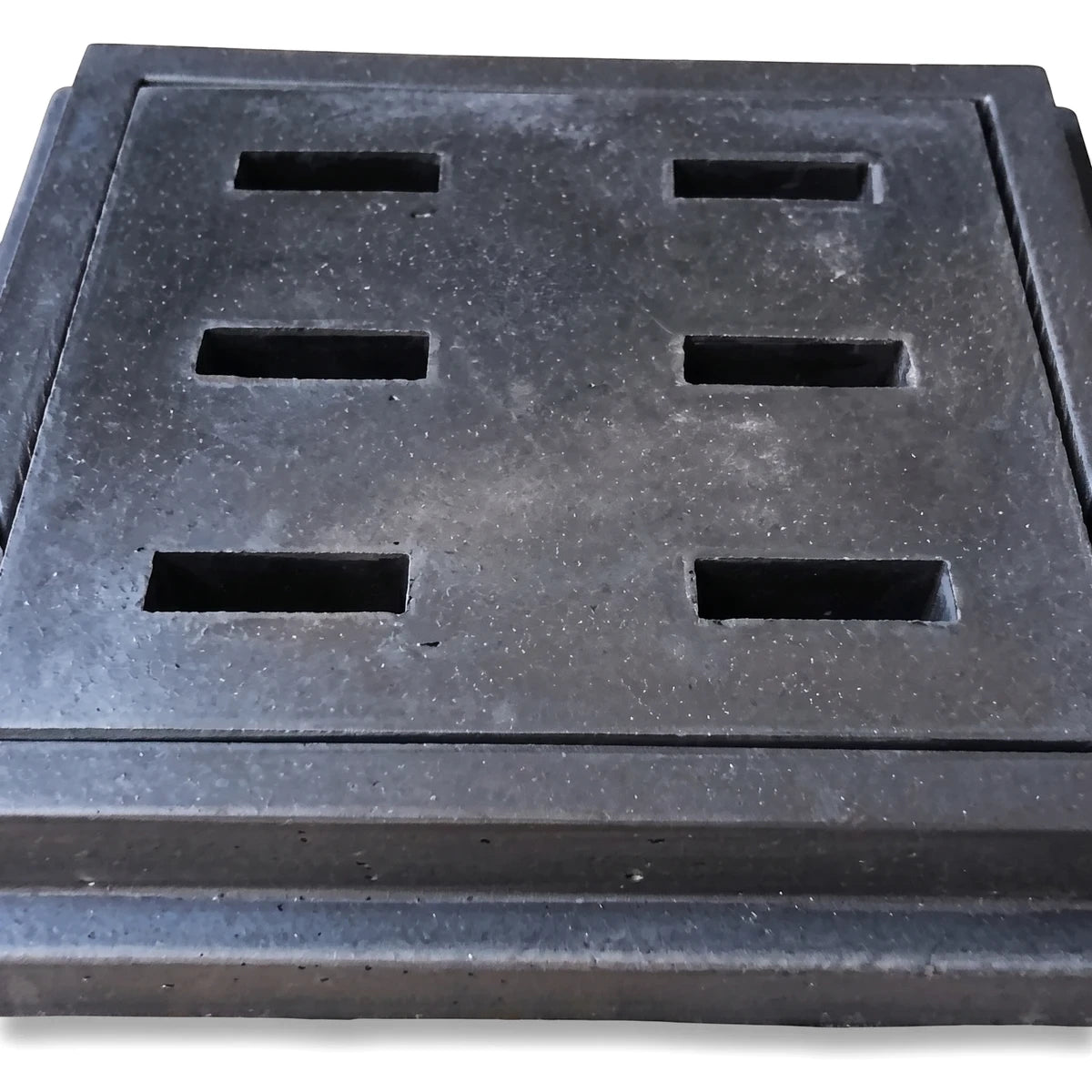 Dark grey heavy-duty square manhole access cover with six rectangular slots, viewed from a slight angle.