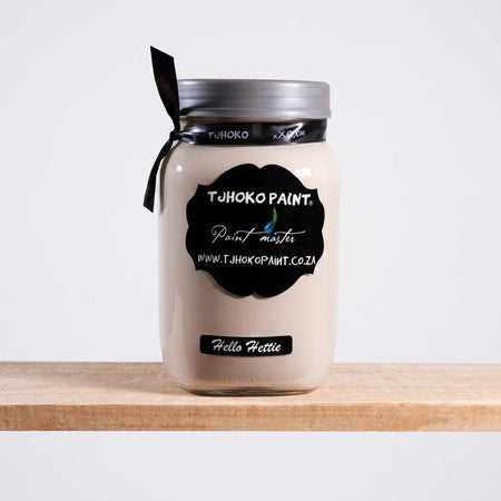 Hello Hettie 25ml Chalk Paint in a glass jar with black labels and a black ribbon, displayed on a wooden surface.