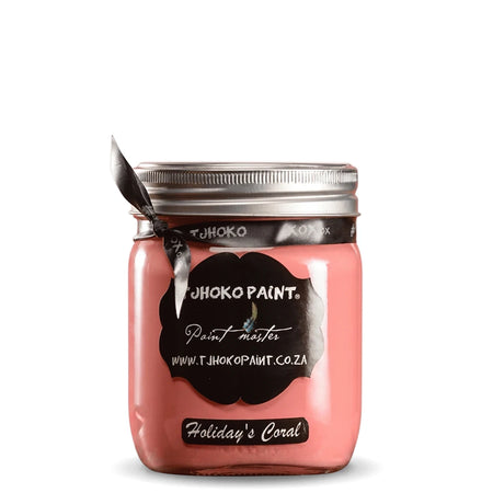 Holiday's Coral 500ml Chalk Paint in a glass jar with a black label and ribbon, showing its vibrant pinkish-coral hue.