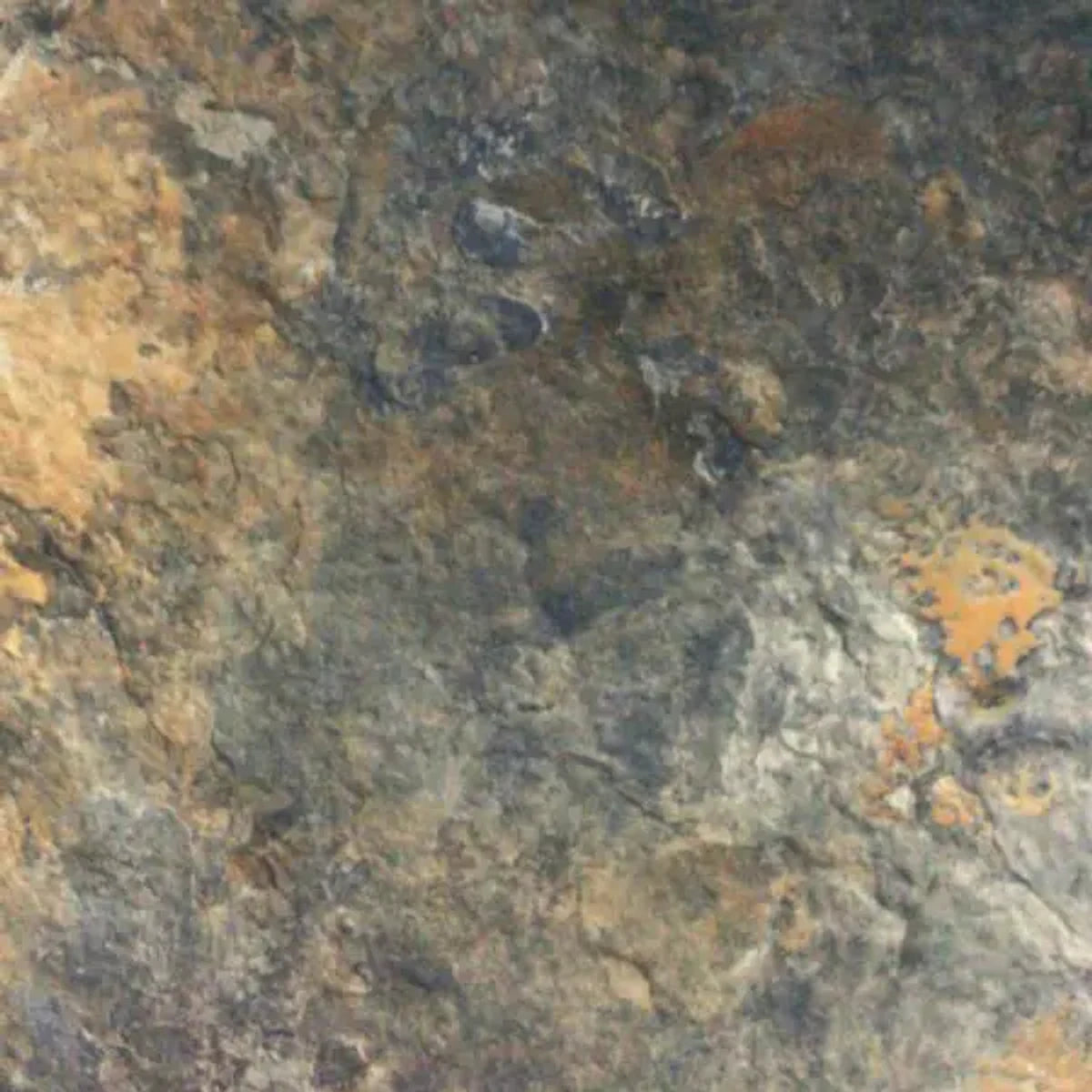 Close-up of Ikapa Cobal natural stone tiles, showcasing their textured surface with multi-toned brown, gray, orange, and