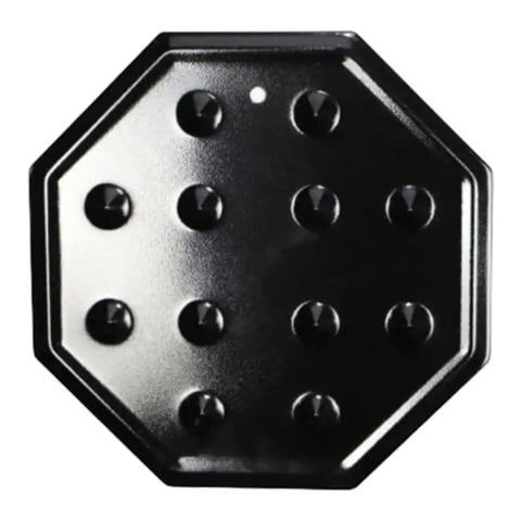black hexagonal simmer plate with round studs across its surface