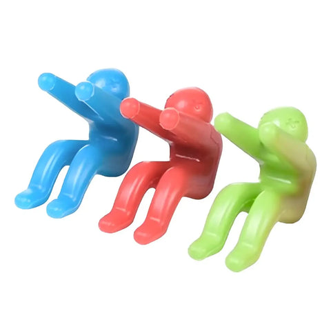 three colorful plastic lid lifters in blue red and green, with arms raised as if lifting a lid