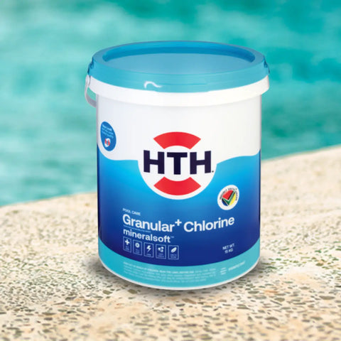 white bucket with blue lid on a poolside surface, brand HTH, granular chlorine mineralsoft label