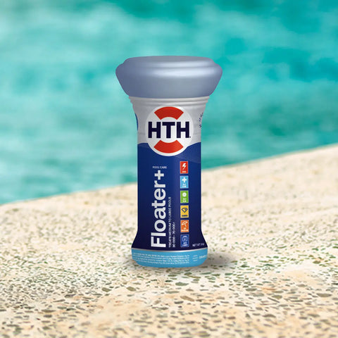 HTH floater plus pool care tablet bottle on a sunlit pool deck with turquoise water behind