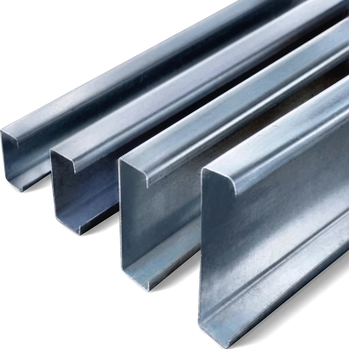 Multiple silver galvanized steel lip channels for construction or drywall applications, arranged diagonally on a light