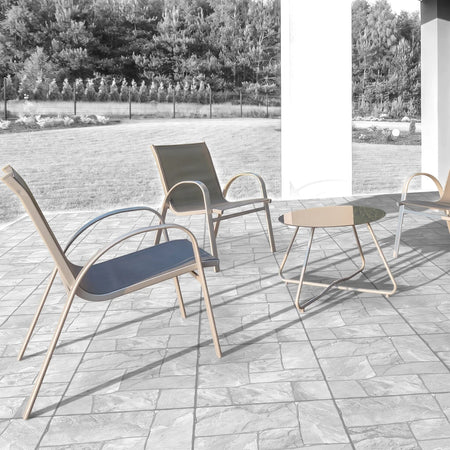 Natural Jabulapave cobblestone 50x50cm tiles laid on a patio, with gray metal outdoor chairs and a glass table.