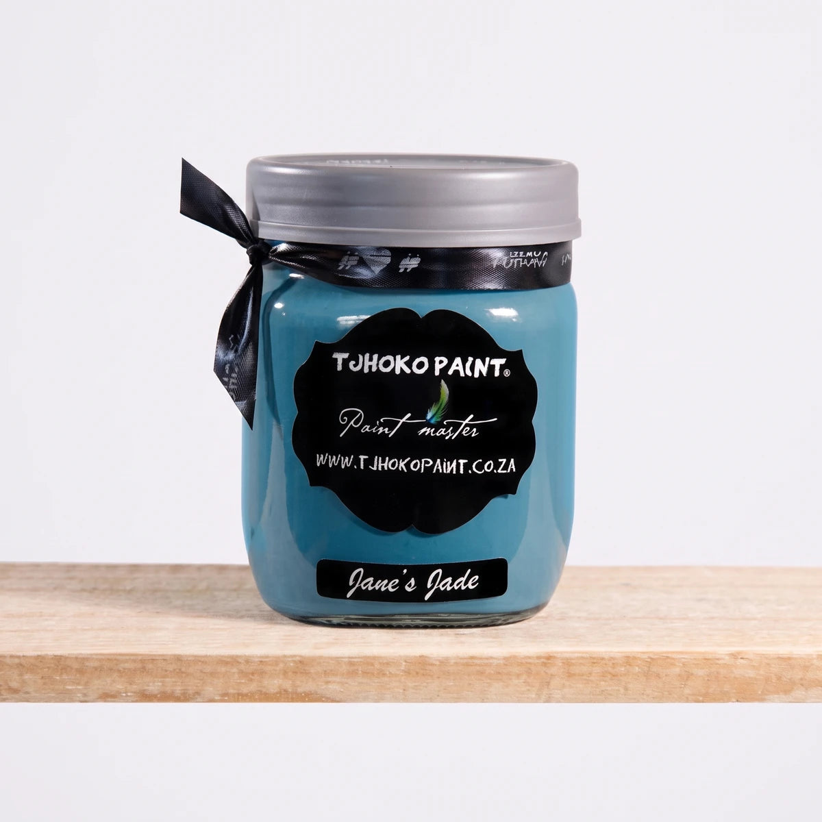 Jane's Jade 500ml Tjhoko Chalk Paint in a glass jar with a black label, gray lid, and ribbon.