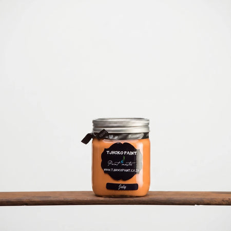 July 500ml Chalk Paint in a clear glass jar with silver screw lid, orange paint shown in front view.