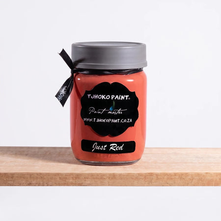 Just Red 250ml Chalk Paint jar by TJHOKO PAINT on a wooden shelf, featuring a black label and gray lid.
