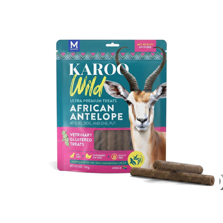 Karoo Wild Rosemary Seasoned Treats Sticks Dog Food package with African Antelope branding and several brown treat sticks.