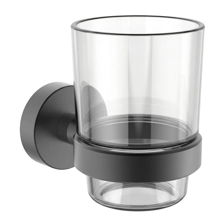 Black wall-mounted glass tumbler holder, front view, with clear glass insert and matte black metal base.