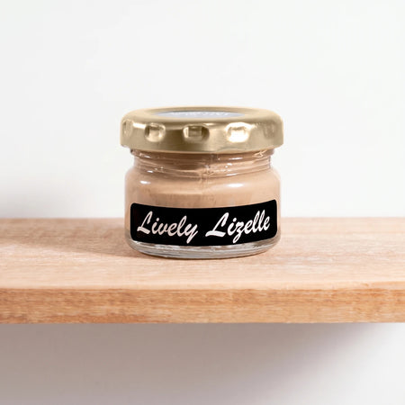 Small glass jar of Lively Lizelle 25ml chalk paint with a gold lid and black label, showcasing the light brown color.