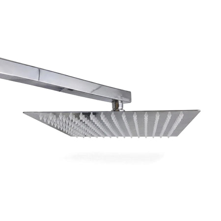Close-up of a square chrome Lluvia shower head with white nozzles and a matching square arm, photographed from a slightly