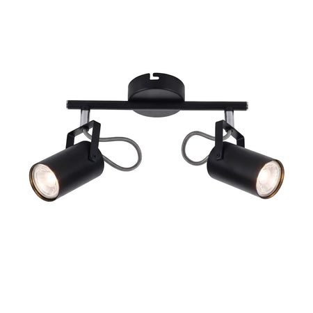 Black metal double spotlight with two adjustable cylindrical lights on a horizontal bar, emitting a bright warm glow.