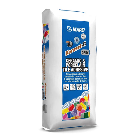White Mapei Keraset-R Grey ceramic and porcelain tile adhesive bag with blue branding and colorful block graphics.