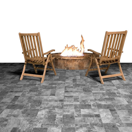 Monzanite Cobblest 50x50cm tiles laid on an outdoor patio with two wooden chairs and a glowing fire pit.