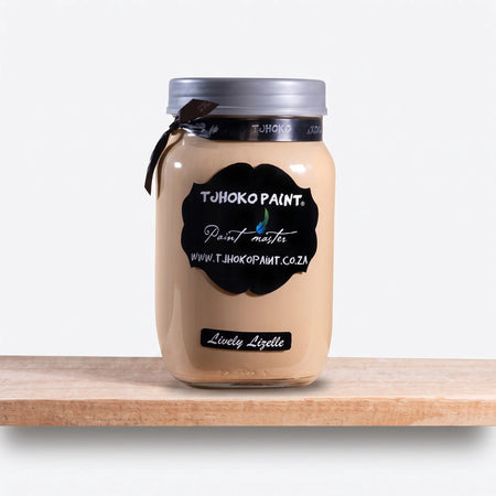 A 1L glass jar of Not Too Shabby Chalk Paint in 'Lively Lizelle' light beige, featuring a black label, silver lid, and a