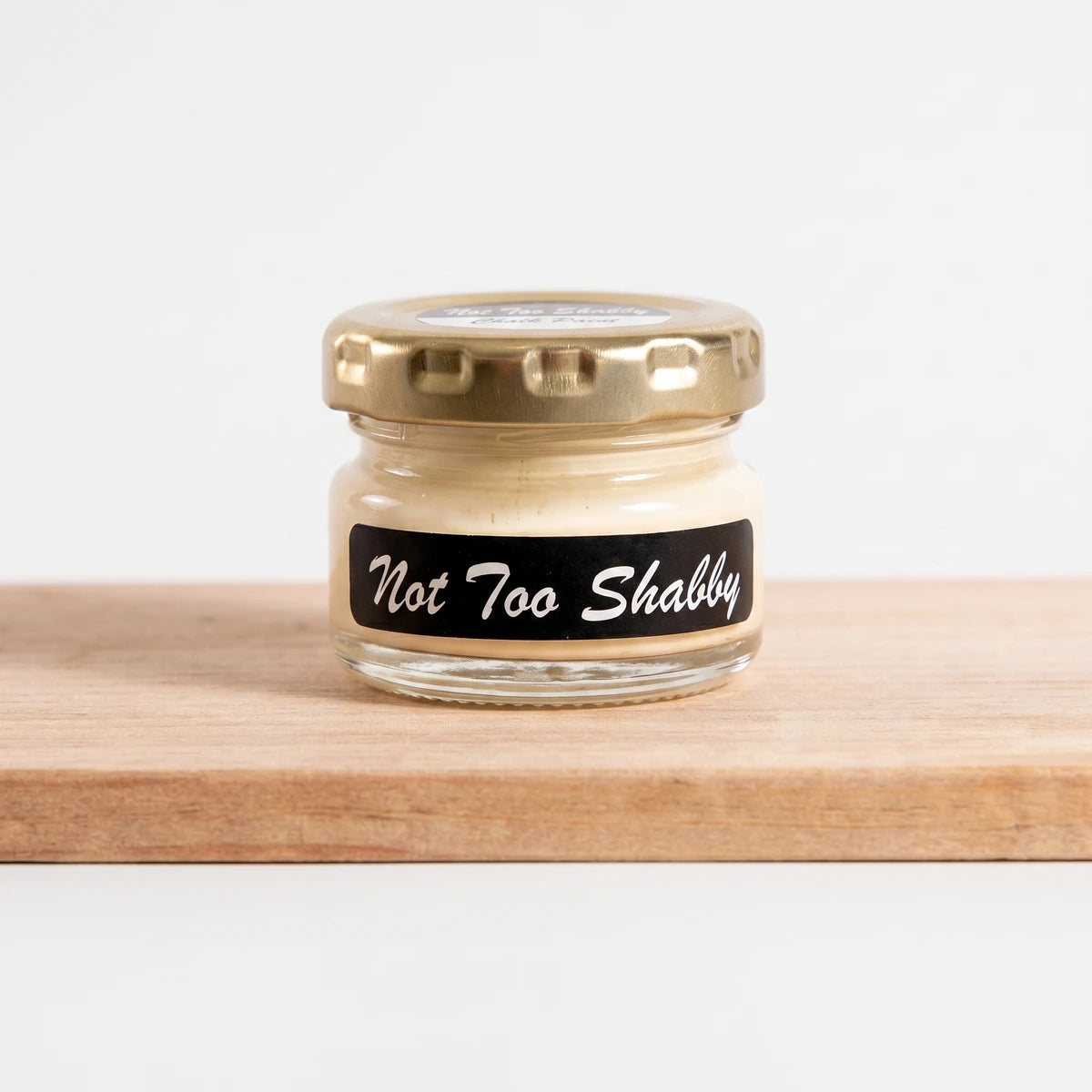 Not Too Shabby 25ml Chalk Paint in a clear glass jar with a gold lid, showcasing the creamy off-white color.