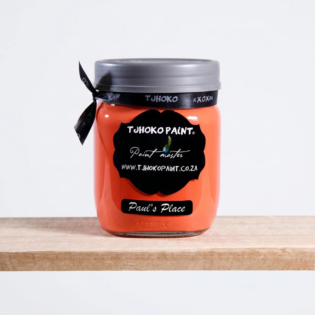 Paul's Place 500ml Chalk Paint in an orange glass jar with a black label on a wooden shelf