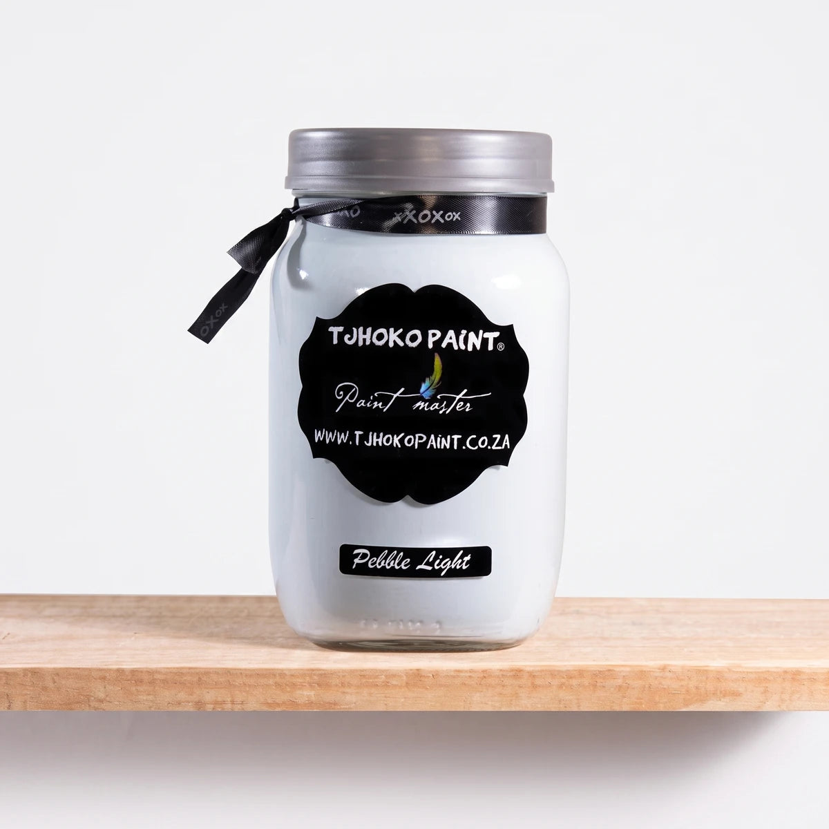 Pebble Light 1L chalk paint in a white jar with a black TJHOKO PAINT label, resting on a wooden shelf.