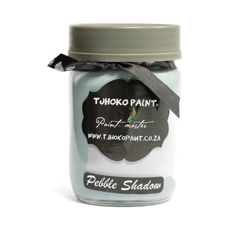 Pebble Shadow 250ml Tjhoko Chalk Paint jar in light blue-grey with a black label and ribbon, studio shot.