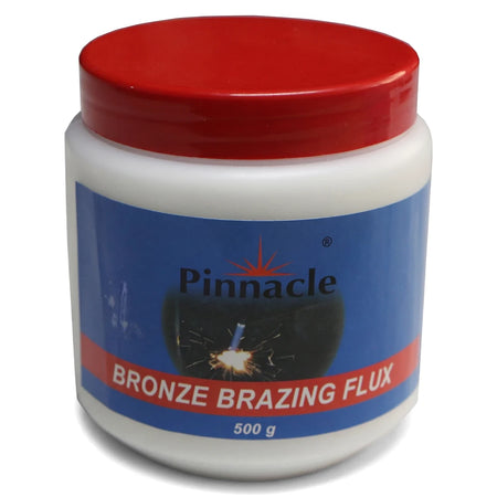 White plastic jar of Pinnacle Bronze Brazing Flux 500g with a red screw-top lid and blue label, shown from an elevated