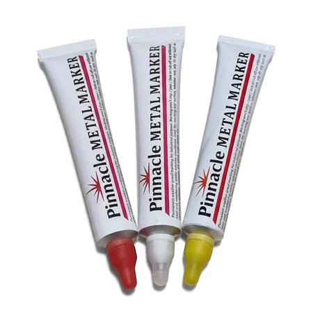 Three Pinnacle permanent metal markers in red, white, and yellow, displayed diagonally with tips visible.