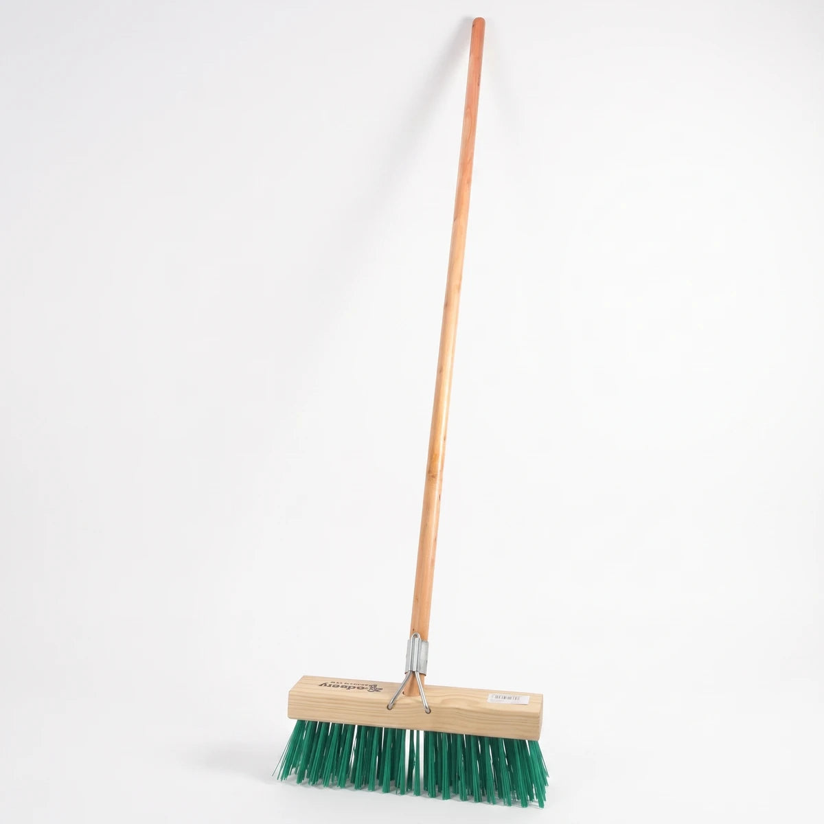 A durable platform broom with a long wooden handle and dense green synthetic bristles for heavy-duty cleaning.