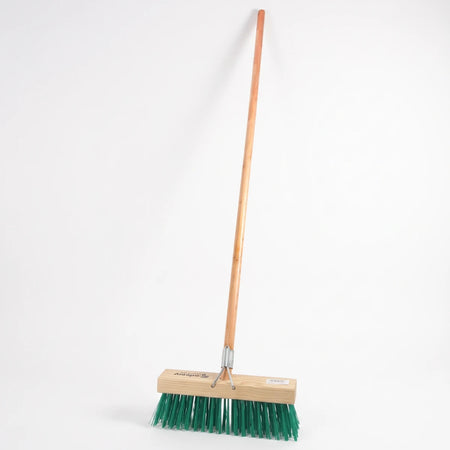 A durable platform broom with a long wooden handle and dense green synthetic bristles for heavy-duty cleaning.