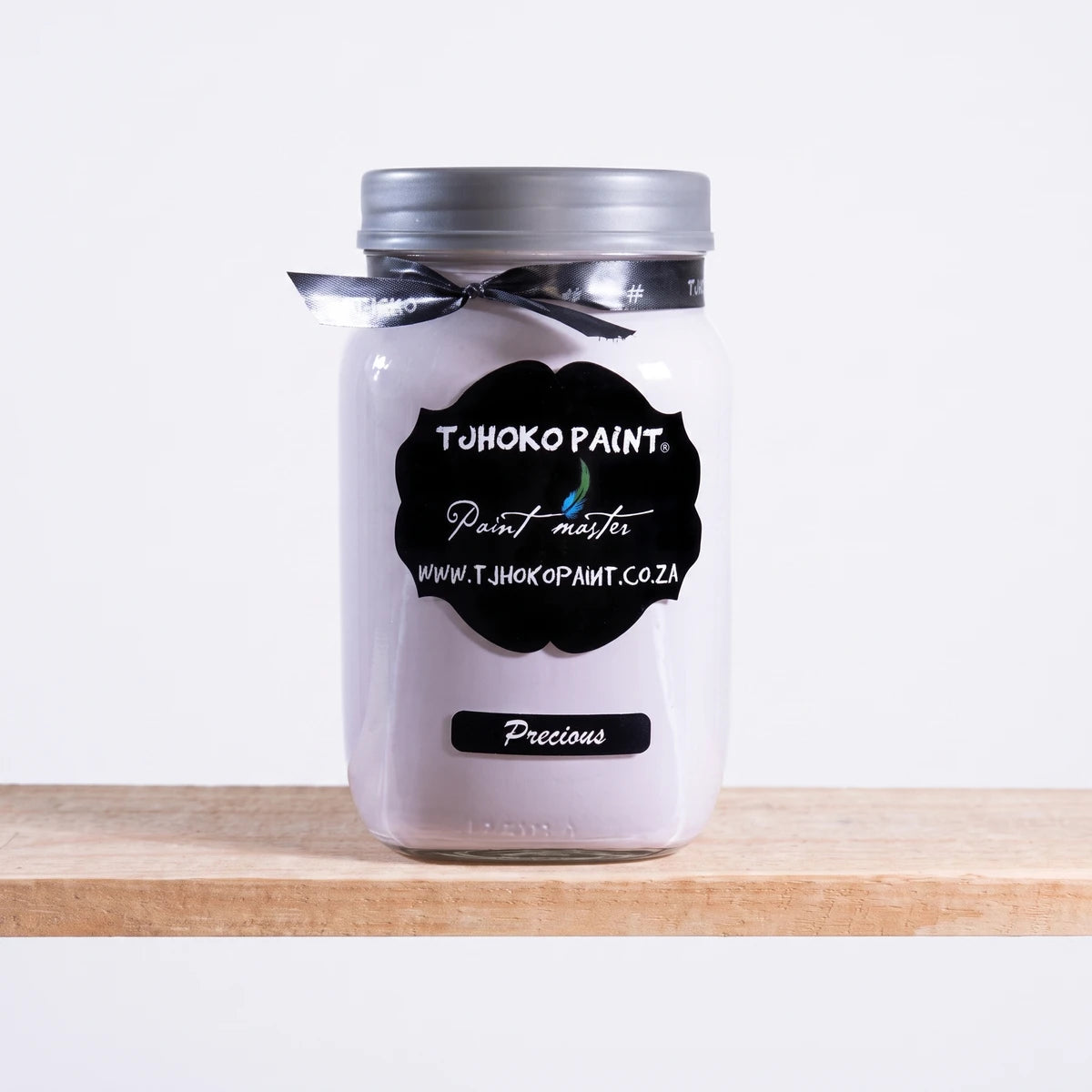 Precious 1L Chalk Paint by TJHOKO PAINT in a clear glass jar with a silver lid and black label, displayed on a wooden shelf.