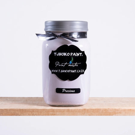 Precious 1L Chalk Paint by TJHOKO PAINT in a clear glass jar with a silver lid and black label, displayed on a wooden shelf.