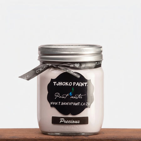 Precious 500ml TJOHOKO PAINT chalk paint in a clear glass jar with a silver lid, presented on a wooden surface.