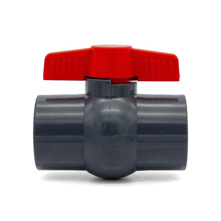 Dark grey PVC lever ball valve with a red handle for plumbing systems, 1 1/2 inch female NPT, front view.