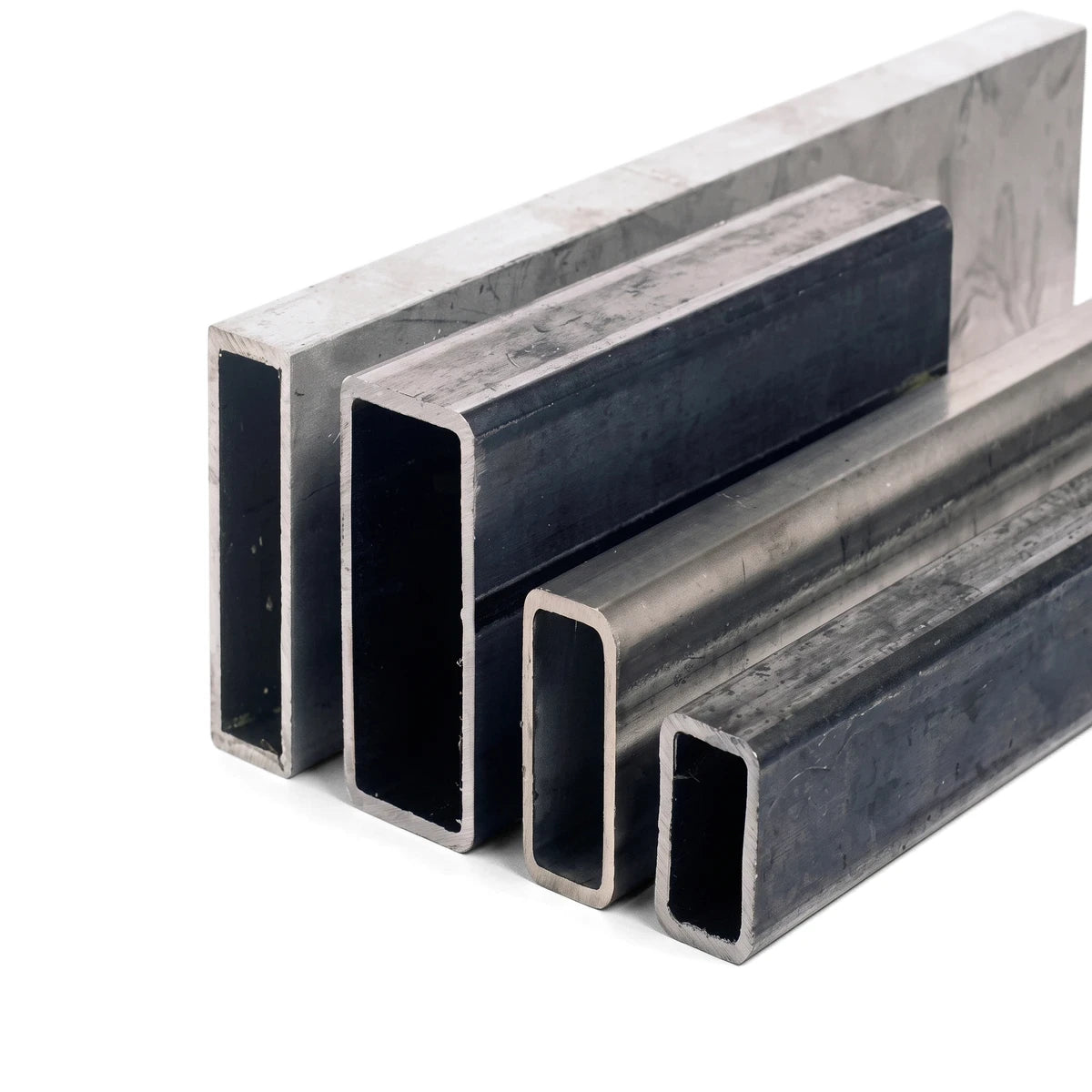 Four rectangular steel tubes of varying sizes, presented in a staggered arrangement, showcasing their hollow profiles and