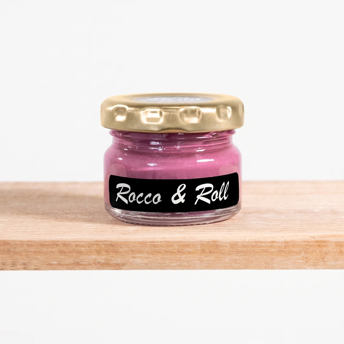 Rocco And Roll 25ml Chalk Paint in a small clear glass jar with a gold lid and a black label, filled with pink paint, on a