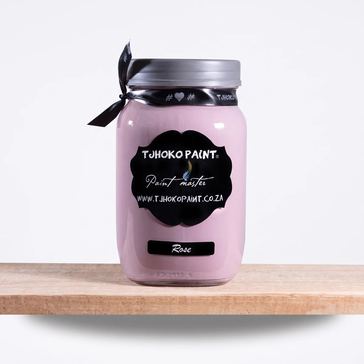 Rose 1Litre Chalk Paint in a clear glass mason jar with a black label and ribbon, displayed on a light wooden shelf.
