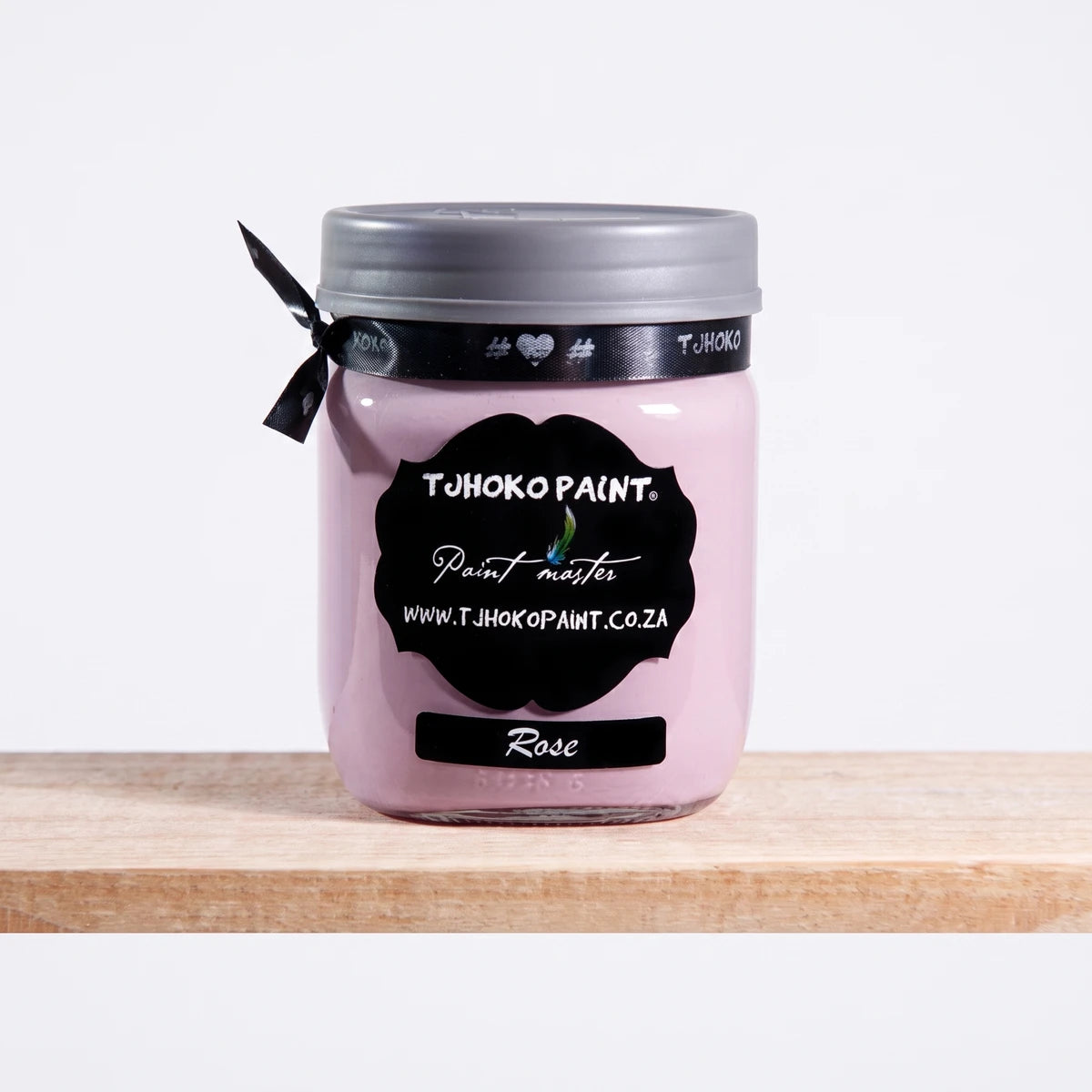 Rose 500ml Tjoko chalk paint in a clear glass jar with a black label, displayed on a wooden shelf.