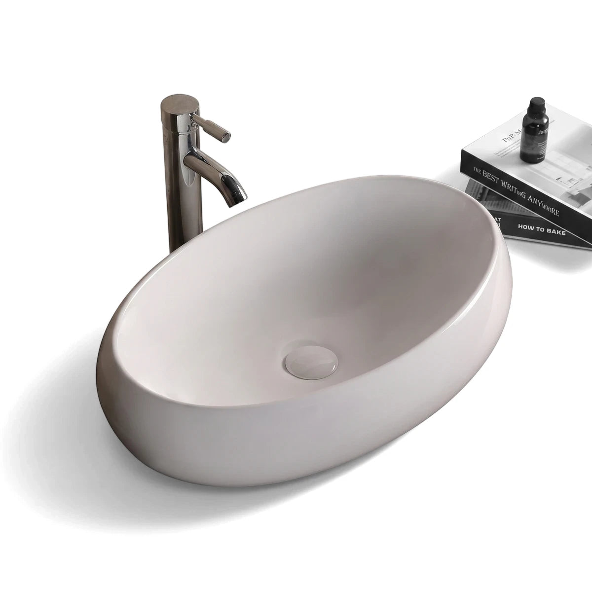 Ruby freestanding basin in white ceramic with an elegant oval shape, shown on a wood countertop with a chrome faucet.
