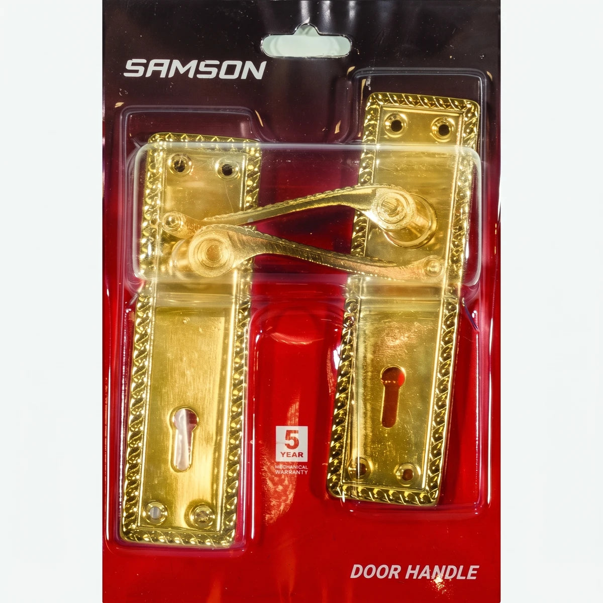 Samson gold door handle set in blister packaging with keyholes and ornate rectangular plates, visible from the front.