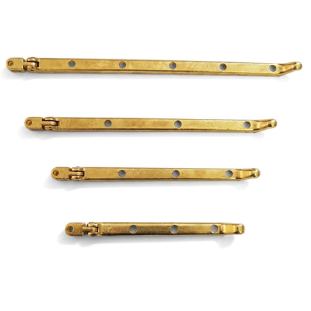 Four solid brass 200mm Samson Stay Pegs for locks and latches, featuring hinges and screw holes, arranged horizontally.