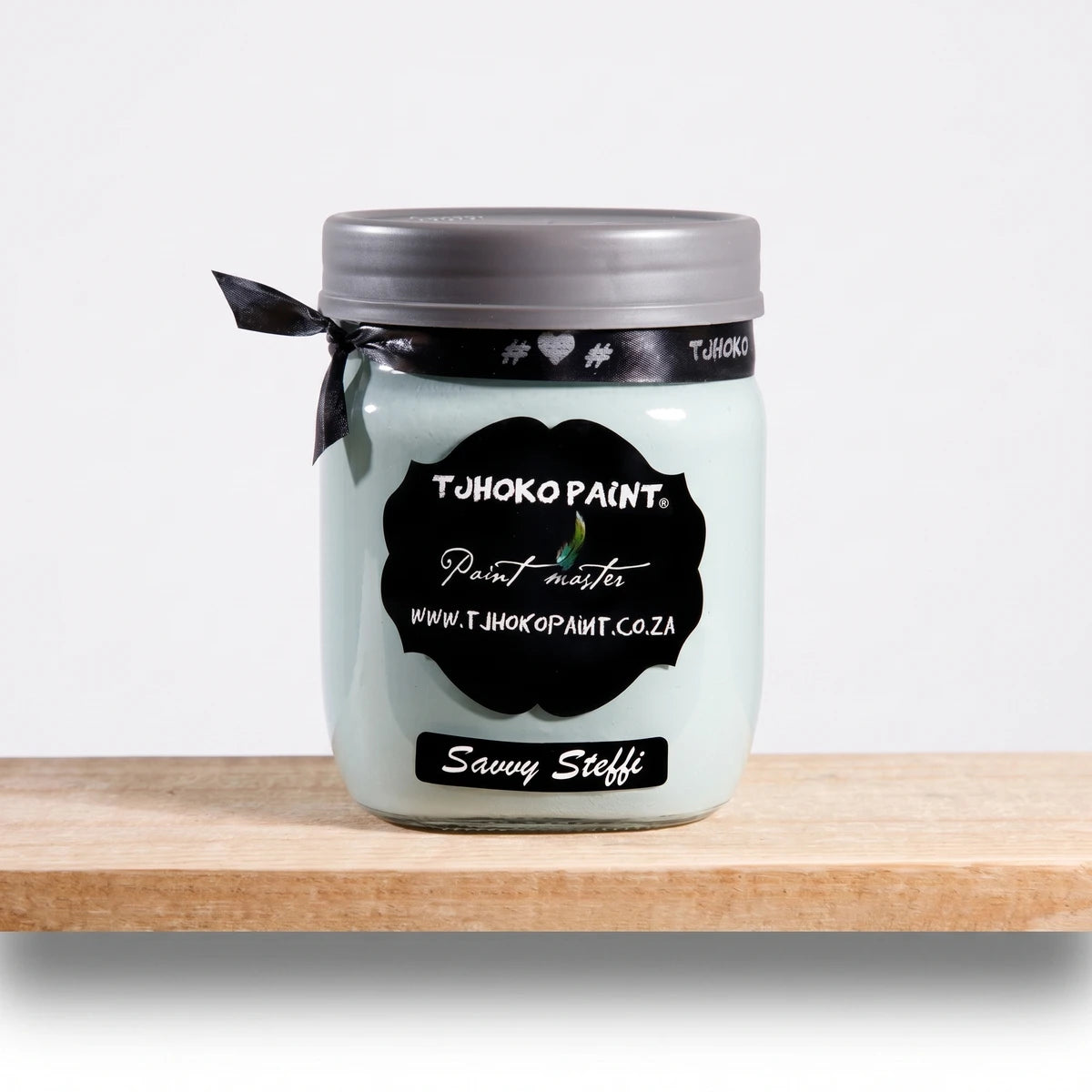 Savvy Steffi 500ml Tjhoko Paint chalk paint jar in light teal on a wooden shelf, featuring a black label and grey lid.