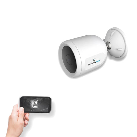 White Securityvue SMARTHOME SVIPC9 indoor IP bullet camera with black lens, shown with a hand holding a smartphone.