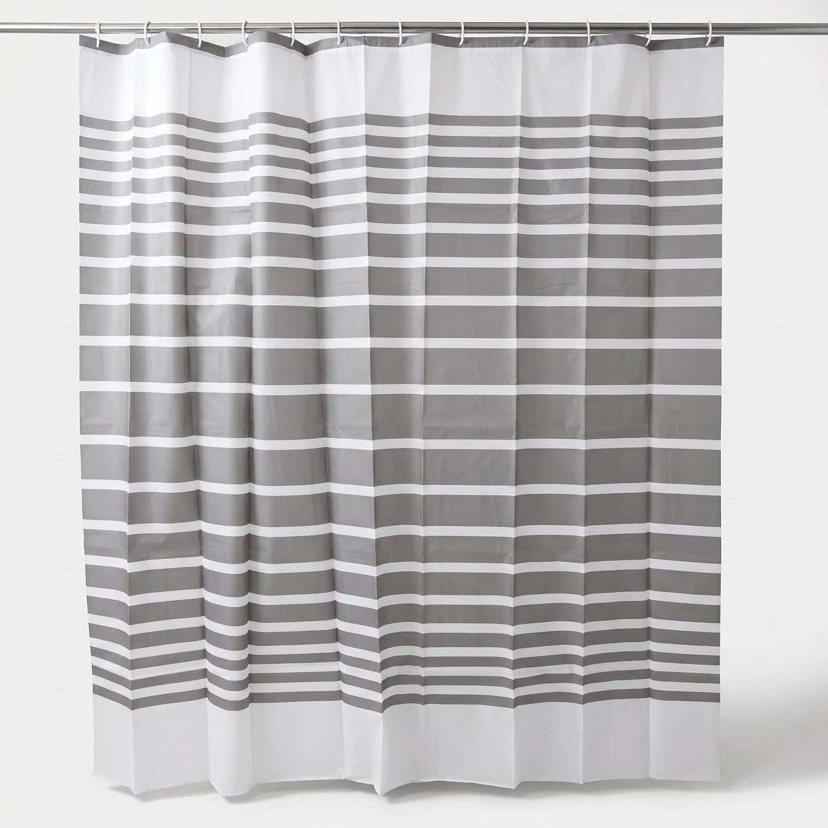 Grey and white striped shower curtain hanging on a rod, showcasing its full length and fabric texture.