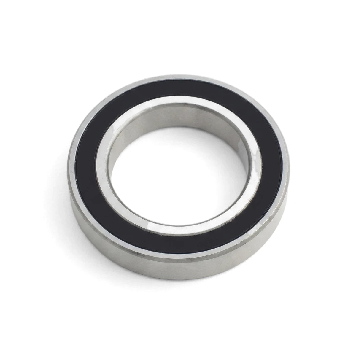 Silver and black metal ball bearing, a precision component with sealed inner and outer races, shown in a close-up, angled