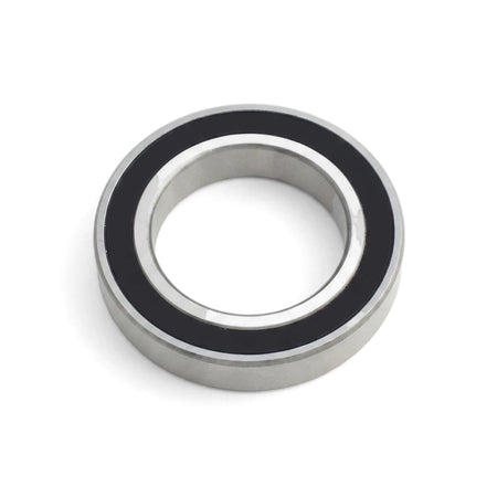 Silver and black metal ball bearing, a precision component with sealed inner and outer races, shown in a close-up, angled