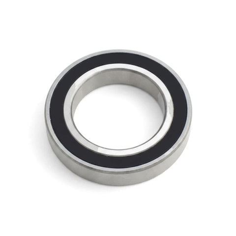 Silver and black metal ball bearing, a precision component with sealed inner and outer races, shown in a close-up, angled